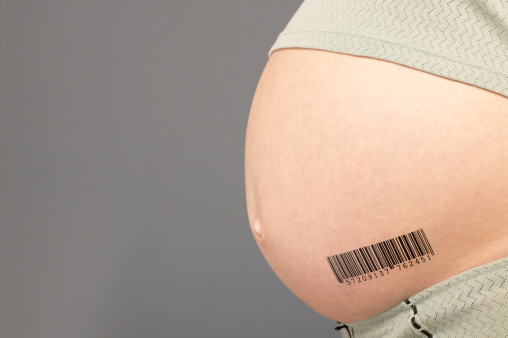 Mid Section View of a Pregnant Woman With a Barcode on Her Stomach